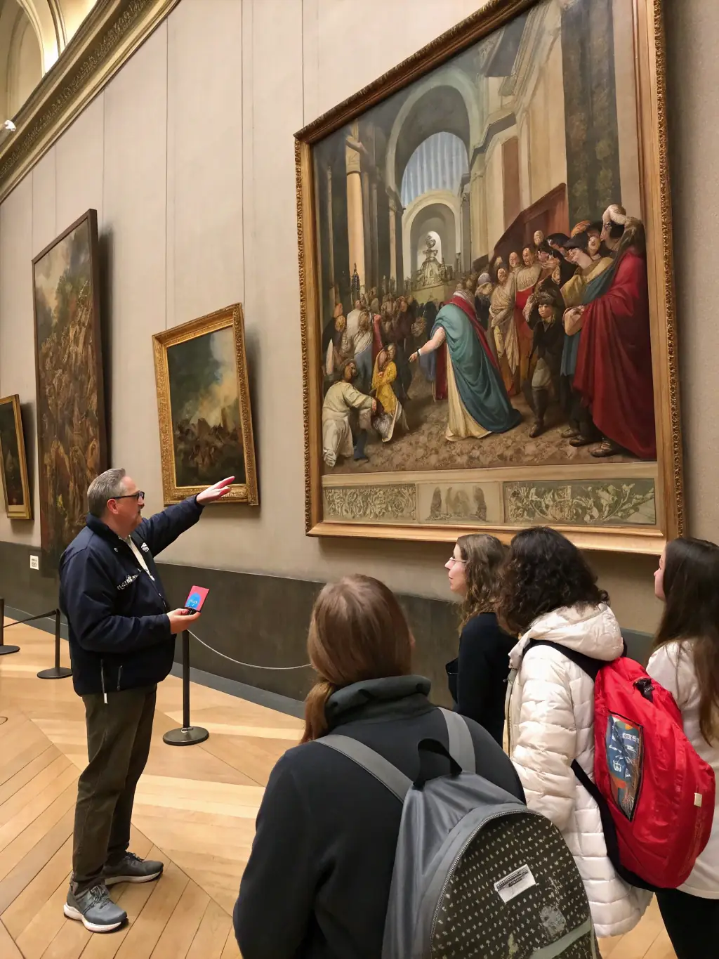 A photograph of a guided tour group exploring the Moulin Forville Museum, with a knowledgeable guide explaining the history and significance of the exhibits.